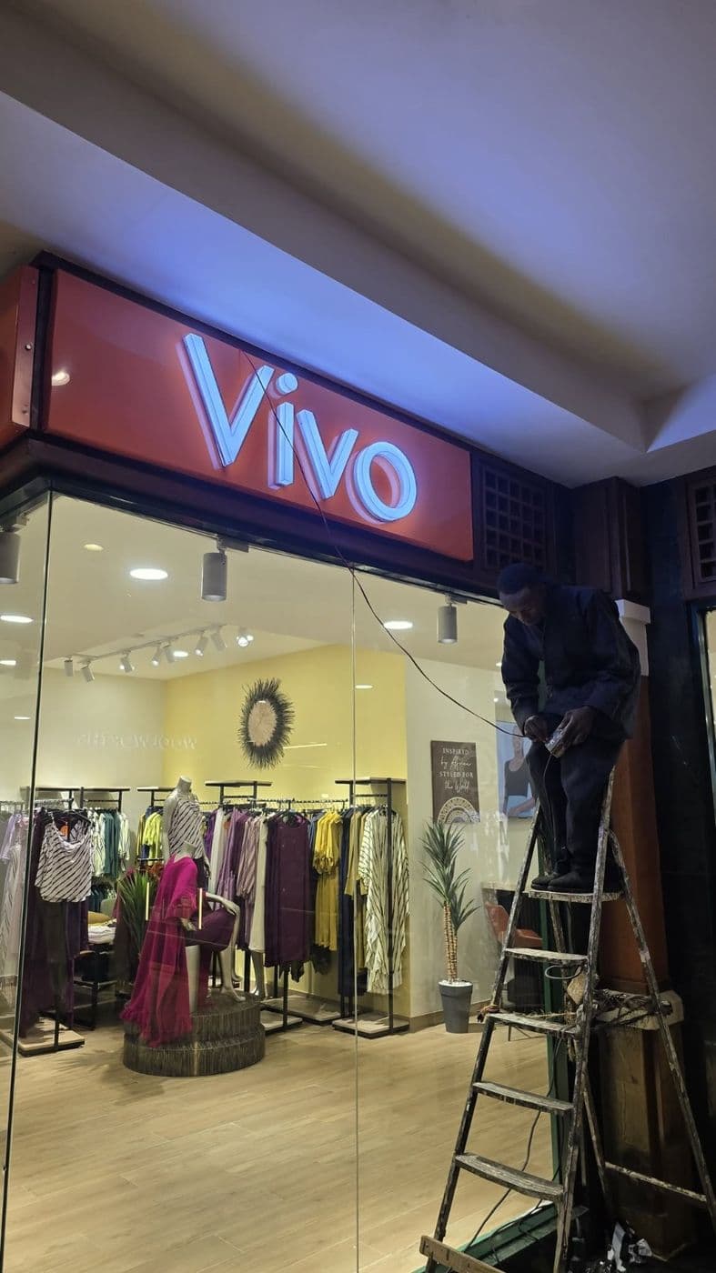Illuminated Vivo shop sign being installed