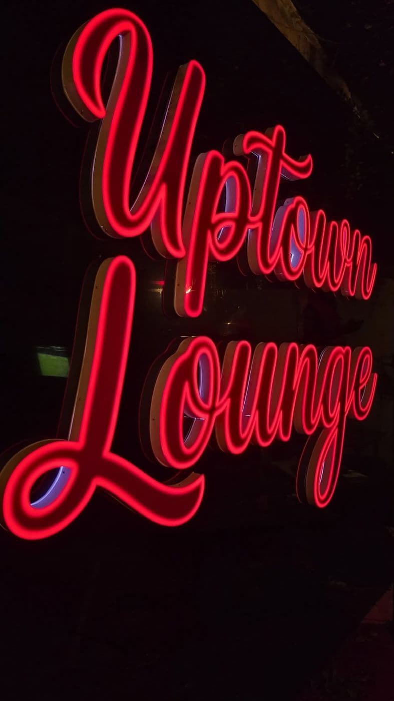 Red neon Uptown Lounge sign